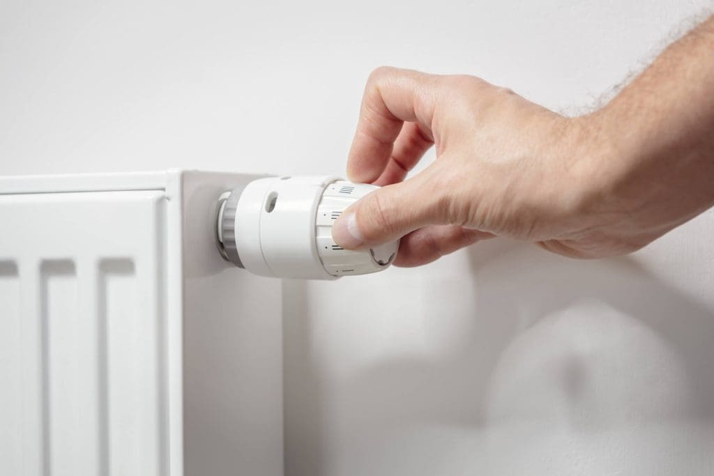 dreamstime_m_343803710 Adjusting temperature on home radiator thermostat central heating control adjustment background