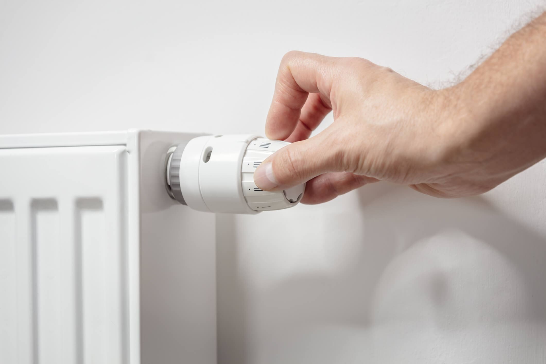 dreamstime_m_343803710 Adjusting temperature on home radiator thermostat central heating control adjustment background